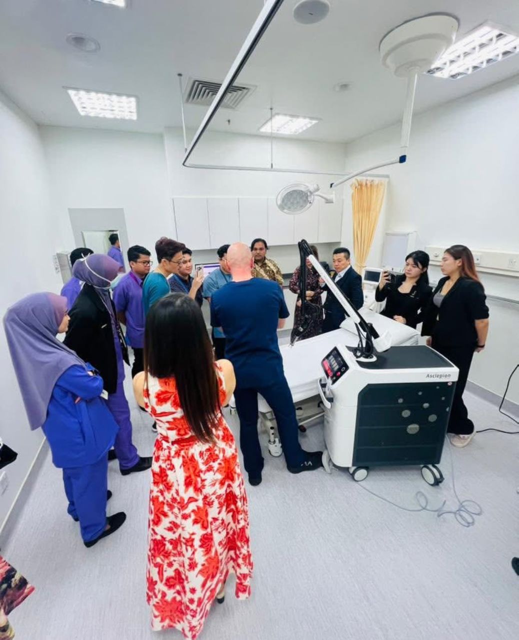 Doctors and nursing staff gathered around an Asclepion Dermablate laser during a device demonstration at Hospital UiTM, Shah Alam