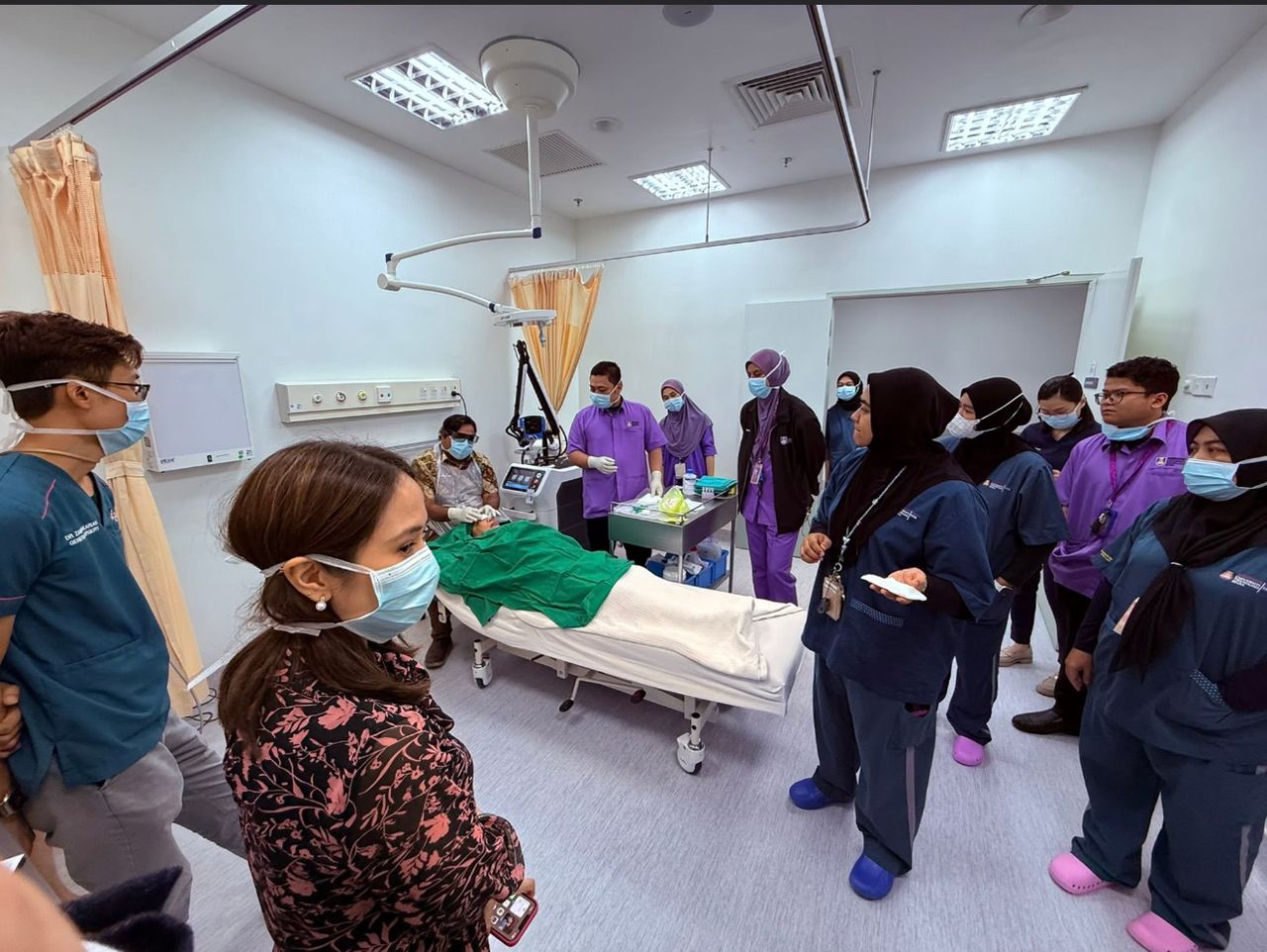 A clinician treating a patient with the Dermablate handpiece while hospital doctors observe during Monarch Medi Solutions training